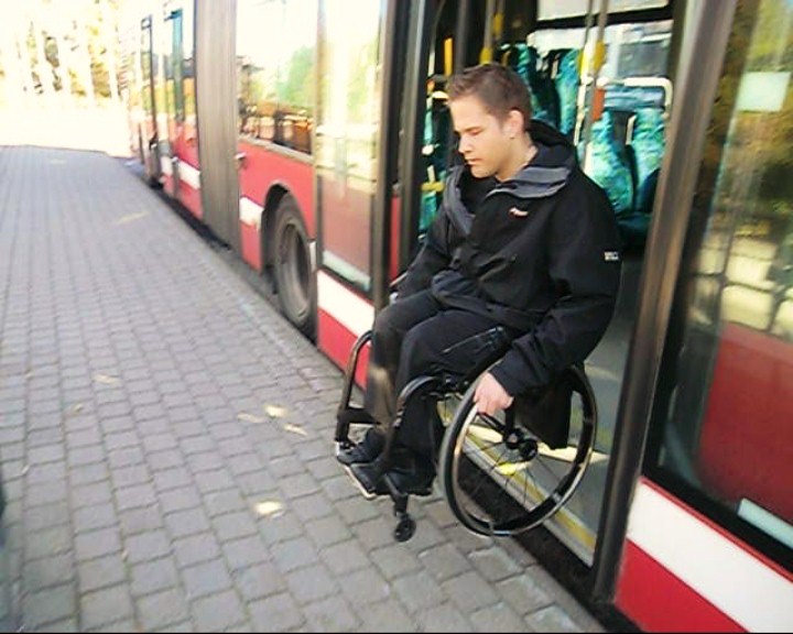 User gets out of a bus. 